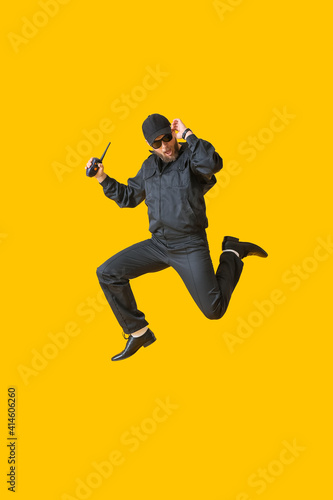 Jumping policeman on color background