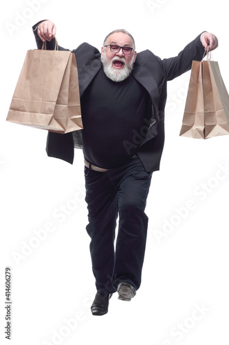 Canvas Print smiling business man with shopping bags striding forward .