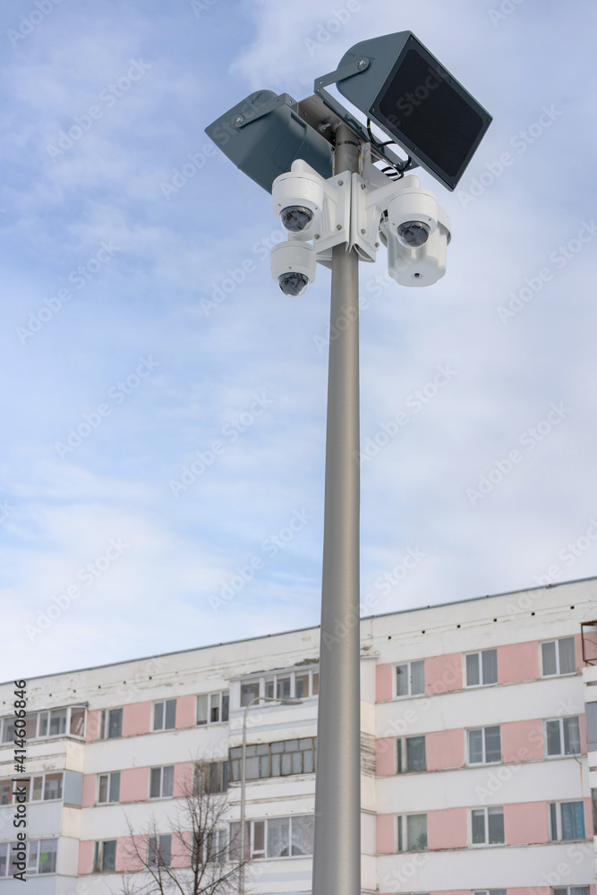 CCTV Security camera with loudspeakers and a megaphone against the sky and an apartment building in Russia. CCTV Security camera with loudspeakers and a megaphone against the sky and an apartment building in Russia.