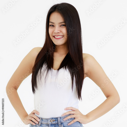 Fototapeta Portrait of One Asian adult woman with long black hair standing, smiling and looking at a camera with hands in blue jean
