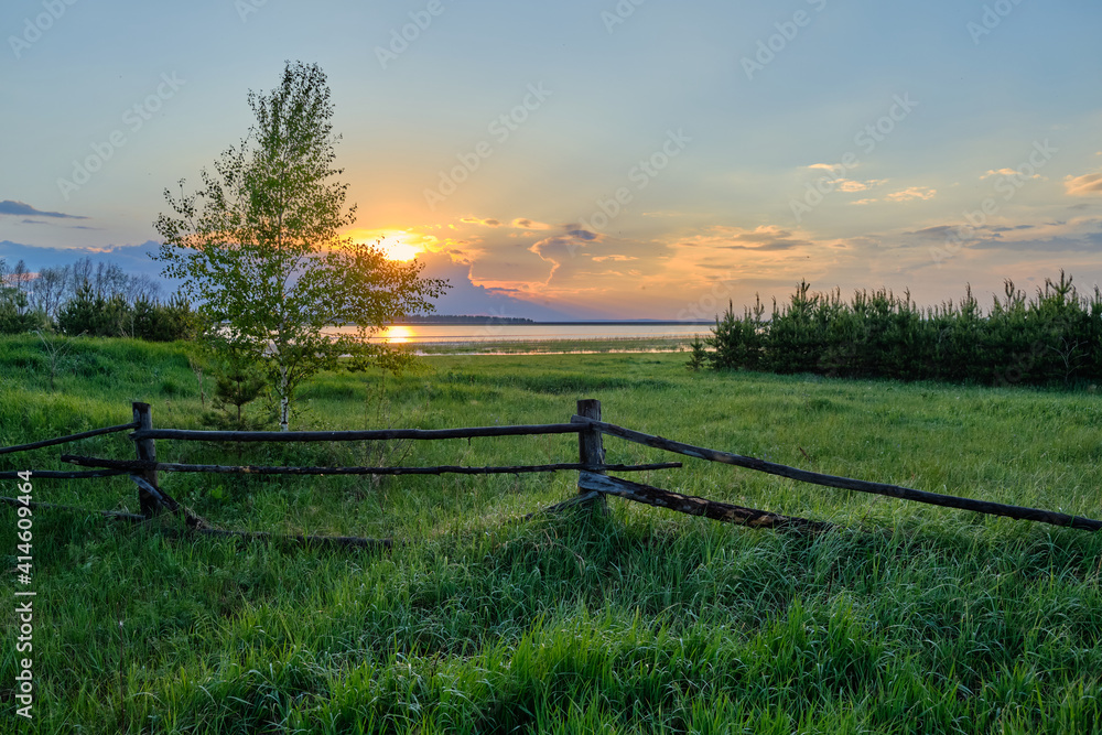 beautiful sunset in the countryside against the backdrop of the lake
