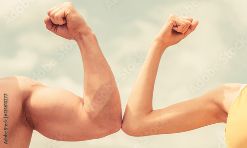 Muscular arm vs weak hand. Vs, fight hard. Competition, strength comparison. Rivalry concept. Hand, man arm fist Close-up. Rivalry, vs, challenge, strength comparison. Sporty man and woman