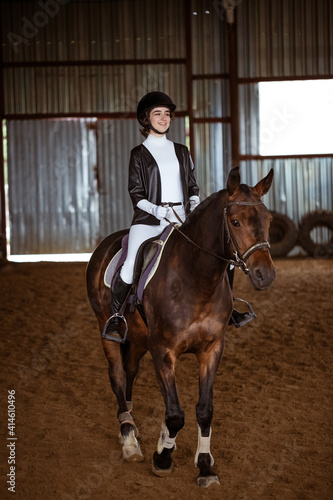 Young woman is engaged in equestrian sports, training on horseback © Екатерина Переславце