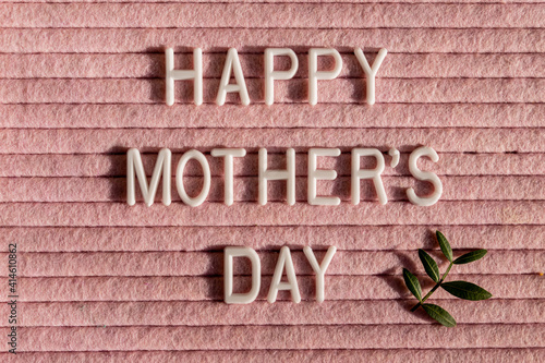 Happy Mother's Day letter board and green leaves.Mother's Day greting card. photo