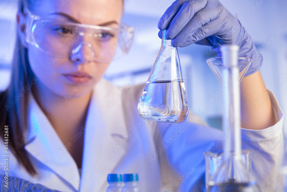 Laboratory concept background. Young scientist during experiment and using microscope in modern laboratory. Laboratory concept background. Young scientist during experiment and using microscope in modern laboratory.