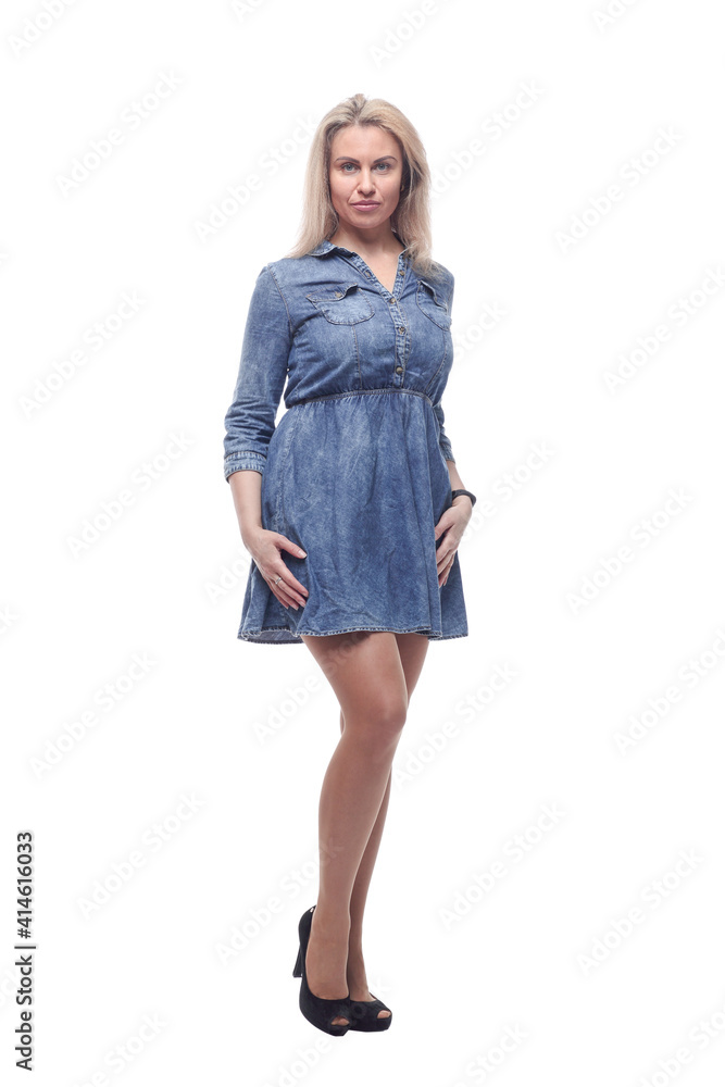 stylish young woman in a denim dress posing for the camera. stylish young woman in a denim dress posing for the camera.