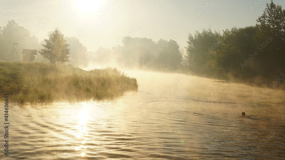 Fototapeta premium colorful summer morning with golden light and fog between hills