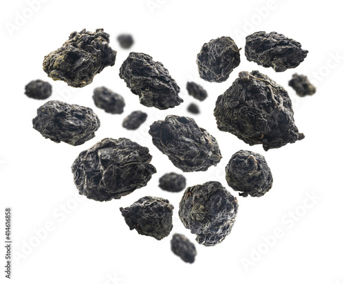 Green oolong tea in the shape of a heart on white background