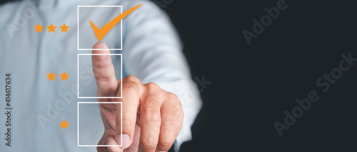 Business people use the index finger to touch the virtual screen to select the starred icons, future digital technology working in digital form, business strategy concepts, human business concepts.