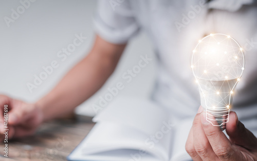 man with a light bulb graphics in his hand and the other side holds white stock graphics, concept idea, concept innovation.