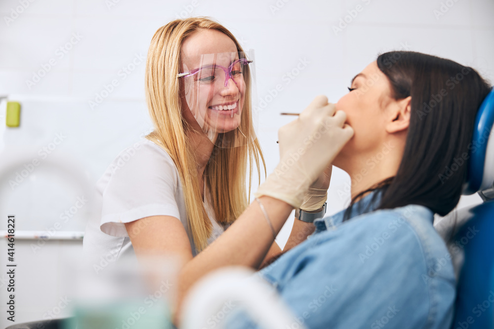 Cute female person enjoying her work in clinic Cute female person enjoying her work in clinic