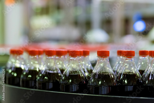 View of plastic bottles at bottling line at soft drinks factory
