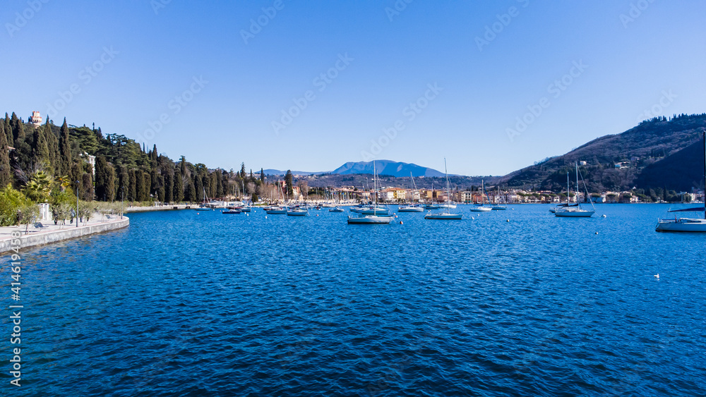Pleasant aerial view of the coast of Lake Garda. A romantic walk in the town of Garda which gives its name to the lake during a sunny day
