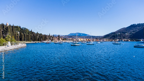 Obraz na płótnie Pleasant aerial view of the coast of Lake Garda. A romantic walk in the town of Garda which gives its name to the lake during a sunny day w salonie