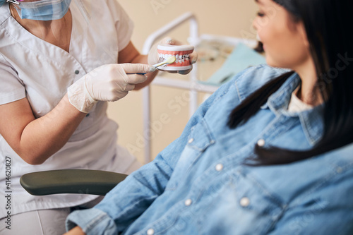 Focused photo on young woman sitting in dentistry chair