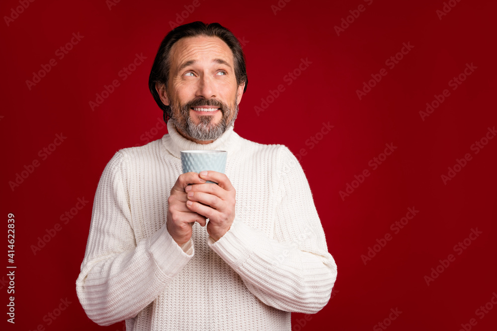 Photo of mature happy good mood smiling cheerful dreamy man drinking hot coffee isolated on red color background Photo of mature happy good mood smiling cheerful dreamy man drinking hot coffee isolated on red color background