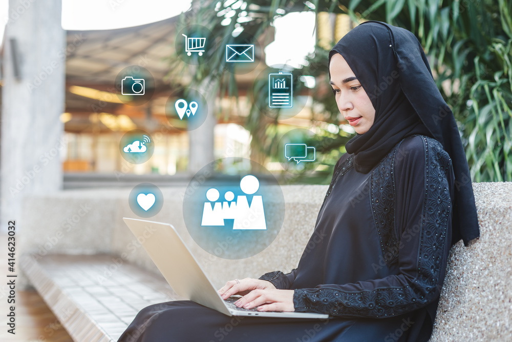 Muslim woman in black hijab working with laptop. Muslim woman in black hijab working with laptop.