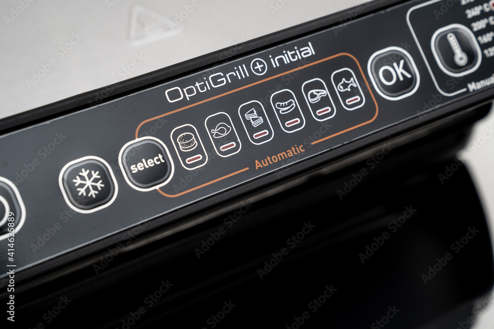 control panel on a black background. electric grill with closed lid. appliance for cooking in everyday life. Made of stainless steel, special non-stick coating. healthy food. food without oil and fat. control panel on a black background. electric grill with closed lid. appliance for cooking in everyday life. Made of stainless steel, special non-stick coating. healthy food. food without oil and fat.