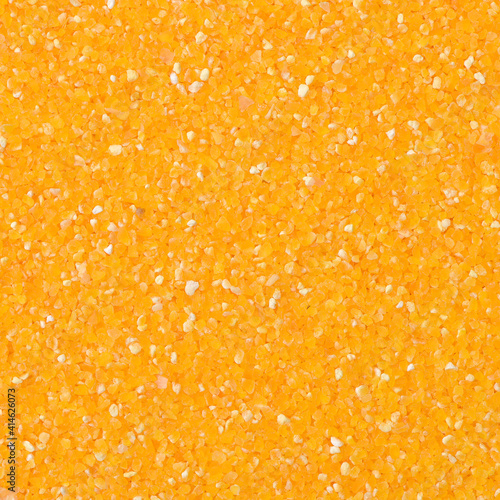 Yellow corn flour and groats texture to background