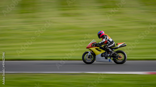 A panning shot of a racing motorbike as it circuits a track. © SnapstitchPhoto