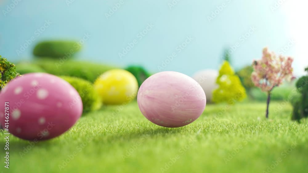 Hand laying easter egg on grass Hand laying easter egg on grass