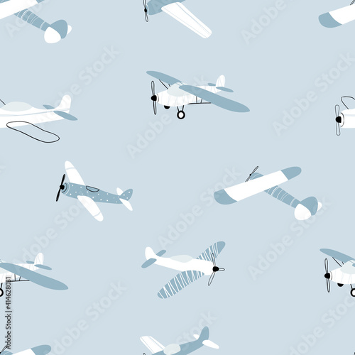 Vector hand-drawn seamless repeating children simple pattern with aircraft in Scandinavian style on a blue background.Kids seamless pattern with planes. Funny airplanes. Trendy vector background.