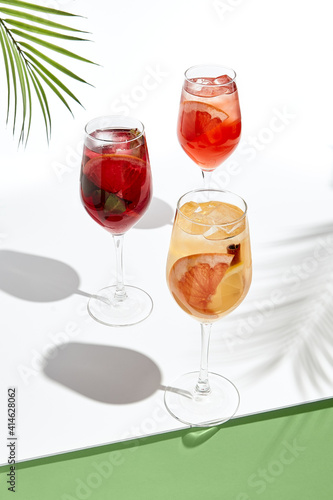 Photo Assortment of sangria drinks on white table