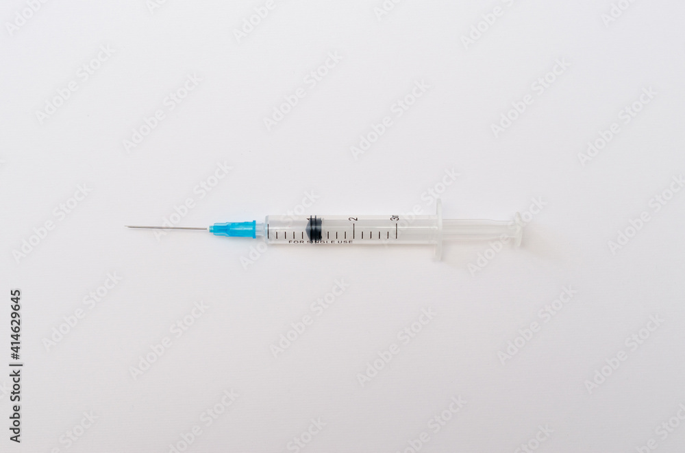 Medical plastic syringe for injection and vaccination on paper background Medical plastic syringe for injection and vaccination on paper background