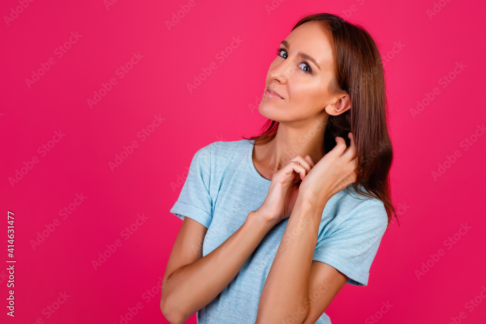 Close-up photo of an impressed lady showing hand gestures, wearing a blue t-shirt isolated on a pink background Close-up photo of an impressed lady showing hand gestures, wearing a blue t-shirt isolated on a pink background
