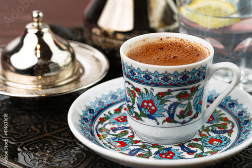 Cup of coffee in oriental style on metal tray