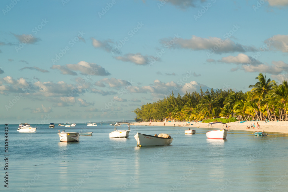 Boats lying in the lagoon at the beach in Le Morne in Mauritius, Africa.