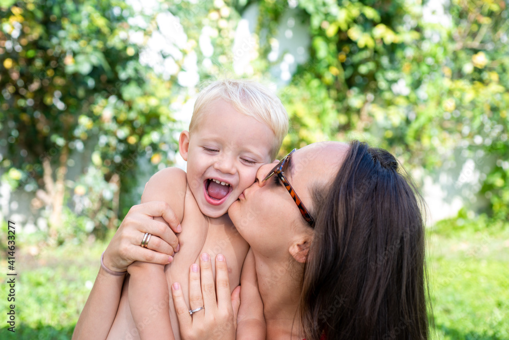 Happy child son hug mom. Family mother and boy smiling and hugging. Happy child son hug mom. Family mother and boy smiling and hugging.