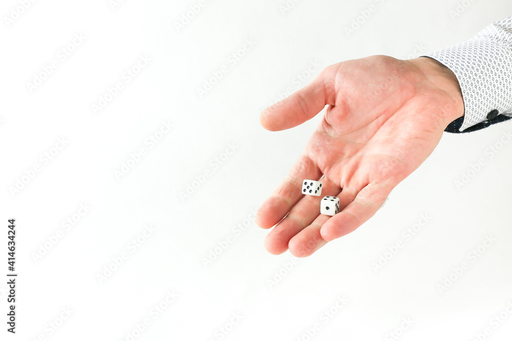 hand throws dice on white background with copy space. 