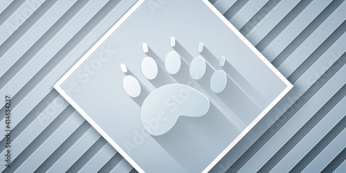 Paper cut Bear paw footprint icon isolated on grey background. Paper art style. Vector.