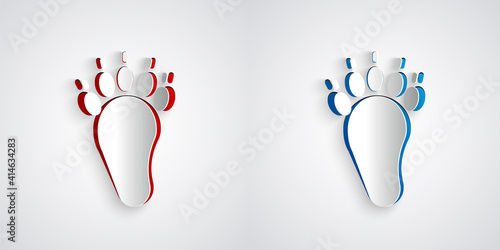 Paper cut Bear paw footprint icon isolated on grey background. Paper art style. Vector.