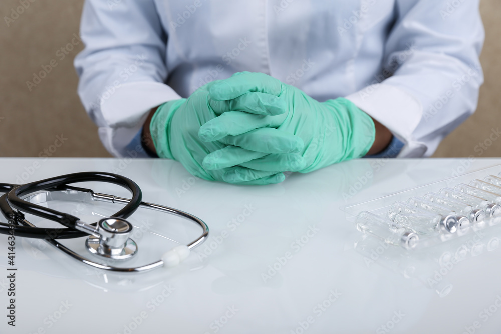 the doctor folded his hands on the table and listens the doctor folded his hands on the table and listens