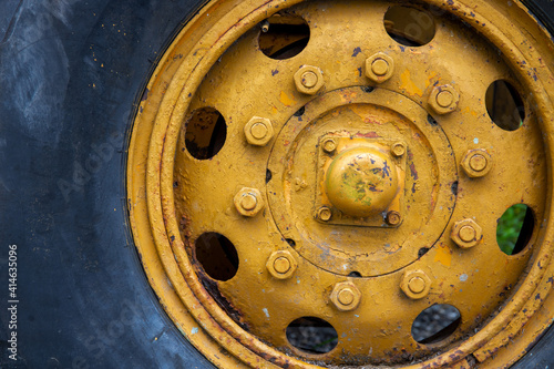 Wallpaper Mural Old yellow wheel with black tire, rustic heavy machine detail photo. Working Tractor or grader detail. Torontodigital.ca