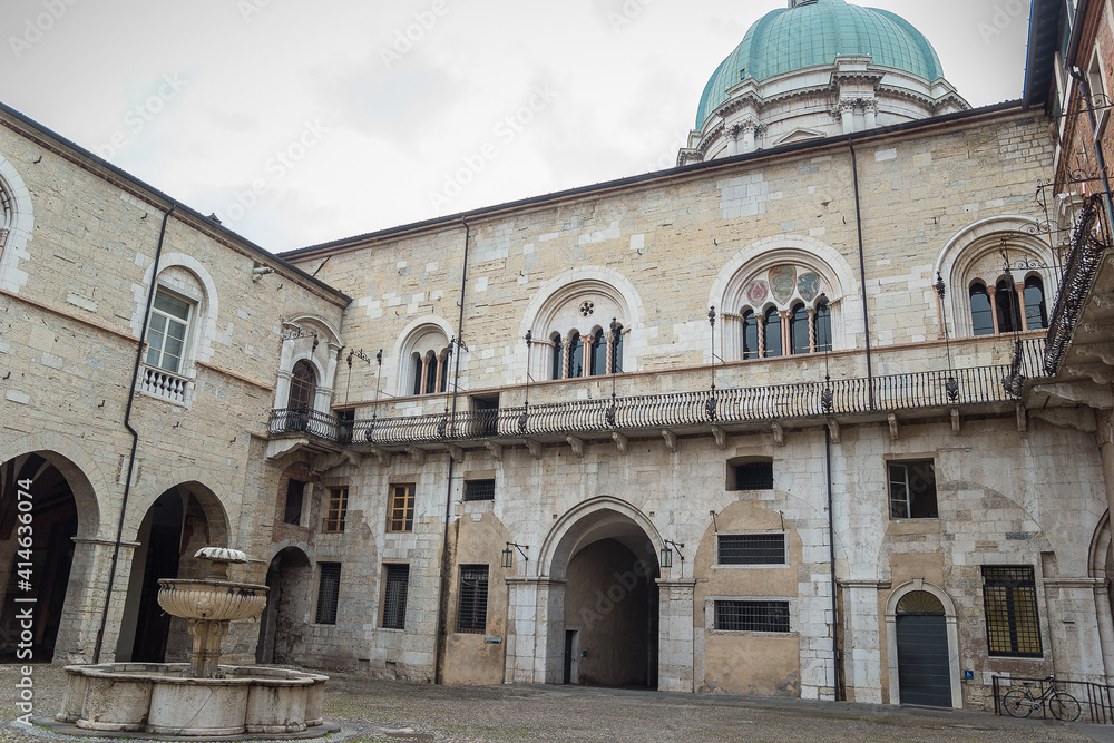 Palazzo Broletto di Brescia. Broletto palace which is now the public office of the town hall of Brescia is very old and is in Romanesque architecture. The large courtyard with a fountain in the center
