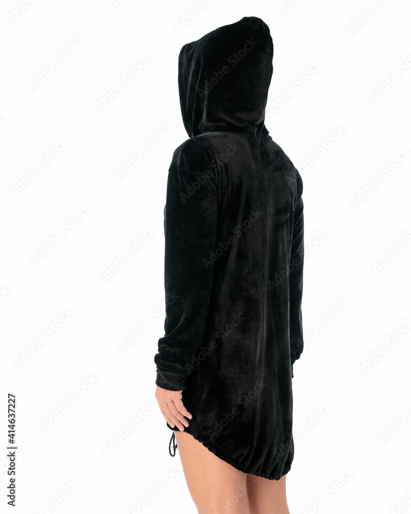 Young woman wearing a black hoodie posing with the back on white isolated background