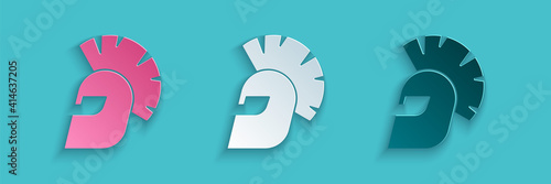 Paper cut Greek helmet icon isolated on blue background. Antiques helmet for head protection soldiers with a crest of feathers or horsehair. Paper art style. Vector.