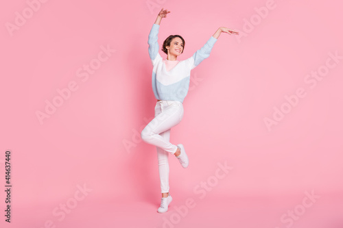 Photo portrait full body view of dancing woman isolated on pastel pink colored background