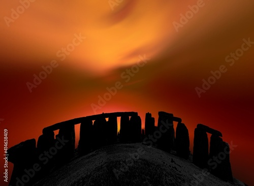 stylized megalith silhouetted against dramatic evening sky