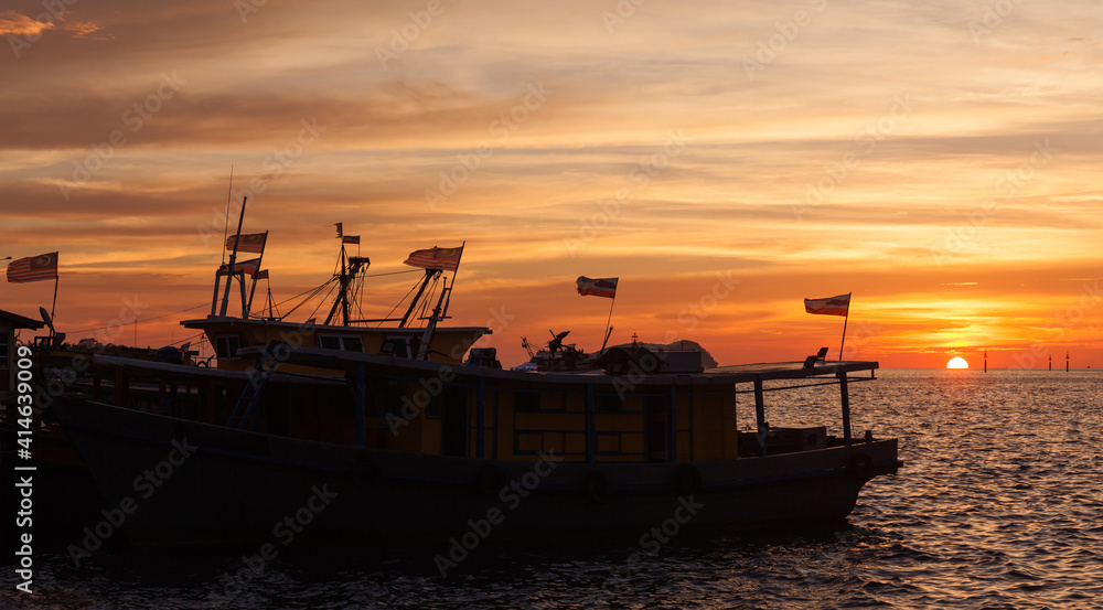 Silhouettes of fishing boats with flags, Malaysia