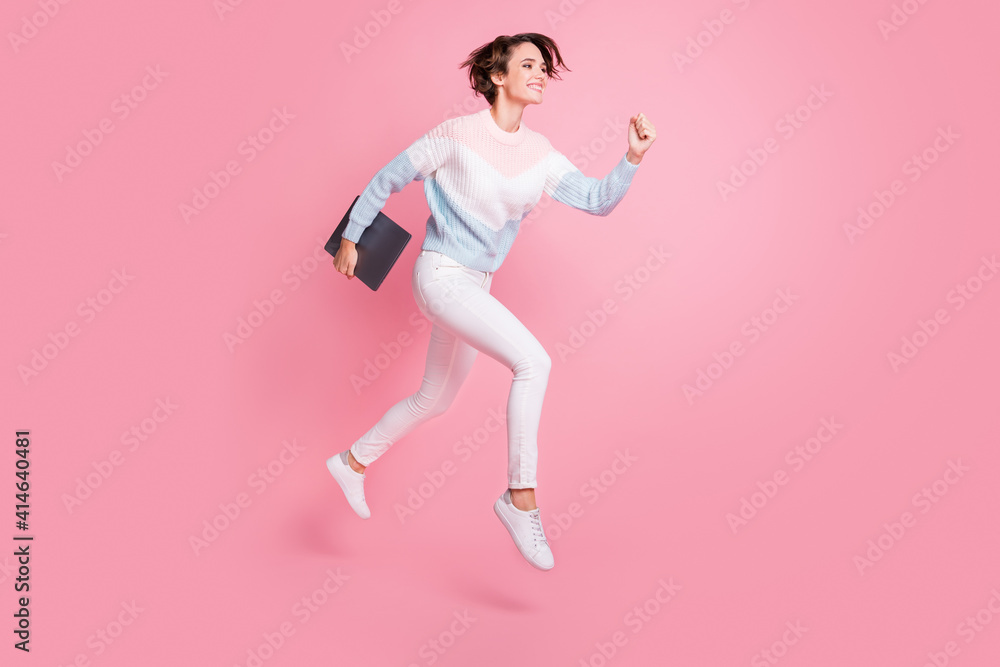 Full length photo of shiny sweet young lady dressed pullover jumping holding modern device isolated pink color background