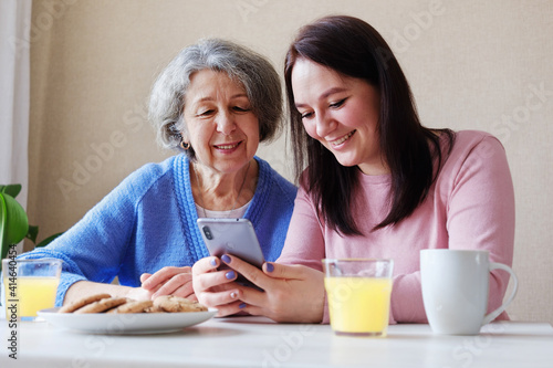 Φωτογραφία Happy two generations of family an elderly mother and a young daughter are havin