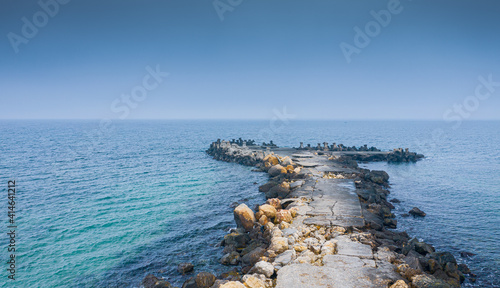 Aerial view of a dock with stabilopods rocks in the Black Sea during a cloudy day photo