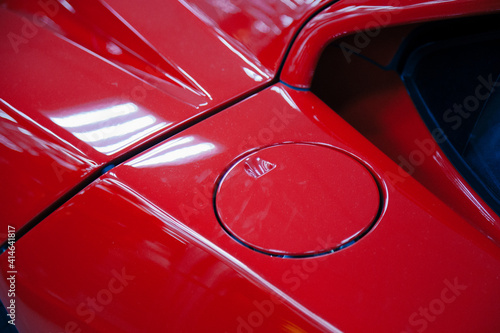 Detail of the red cap from the tank on the car with metallic.