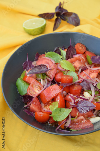 Tomato basil salad with purple basil, lime juice and red onion