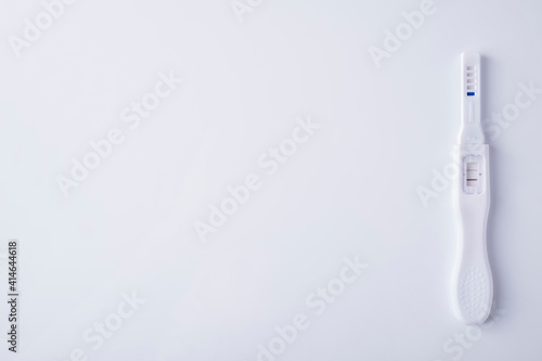 positive pregnancy test on white background. Top view, text space