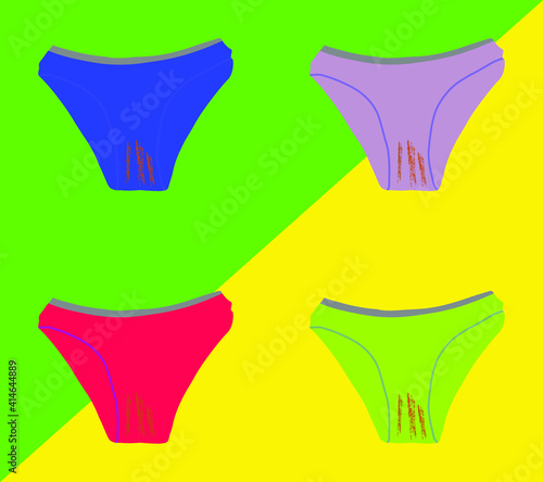 set of four dirty multicolored panties on a yellow-green background